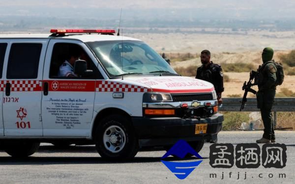 An Israeli policeman and soldier patrol the area near the crossing.