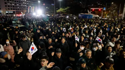 Reuters A crowd of protesters outside parliament chant 